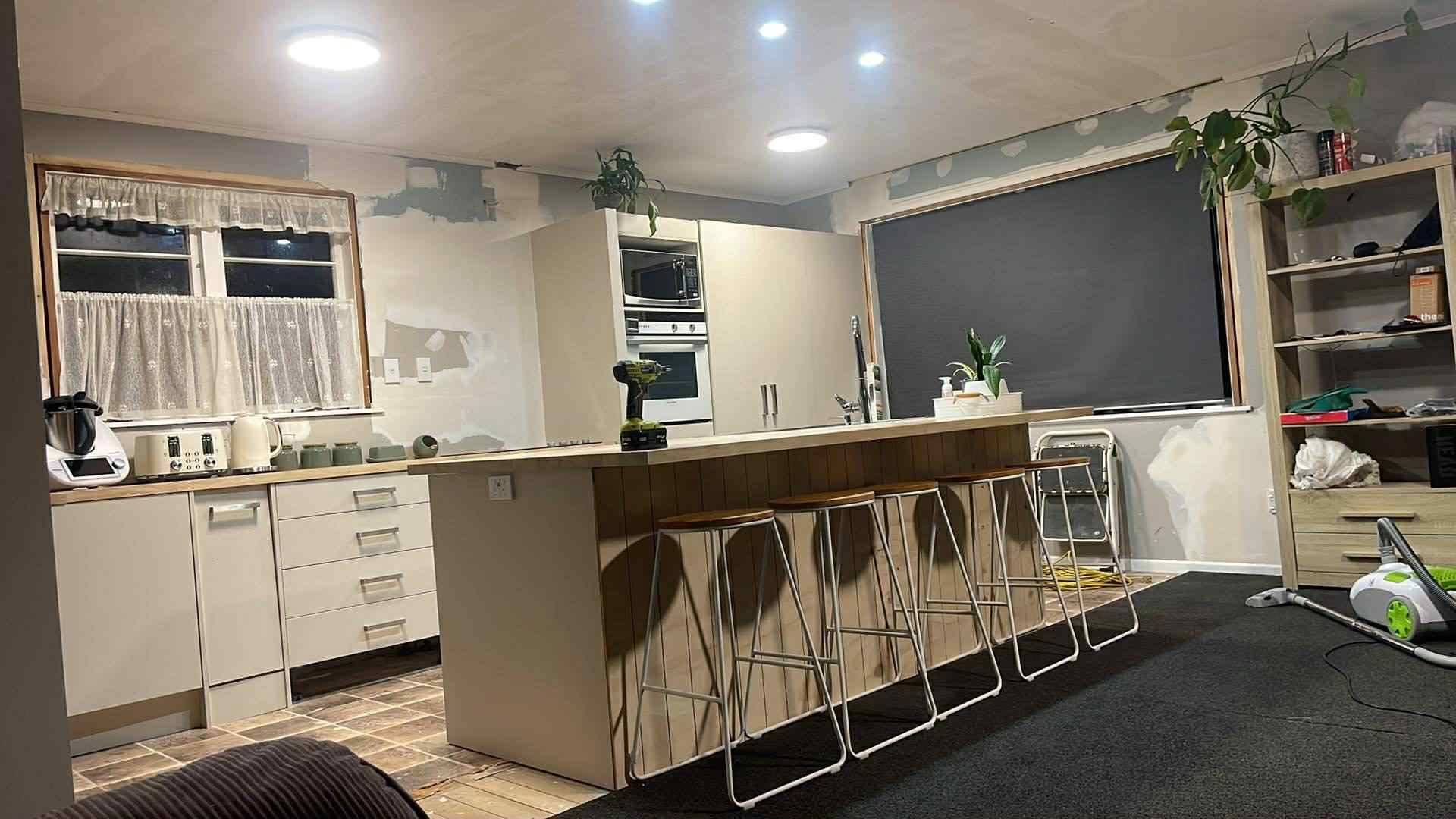 Tara and Jono's completed kitchen - open-plan with island bench and new lighting